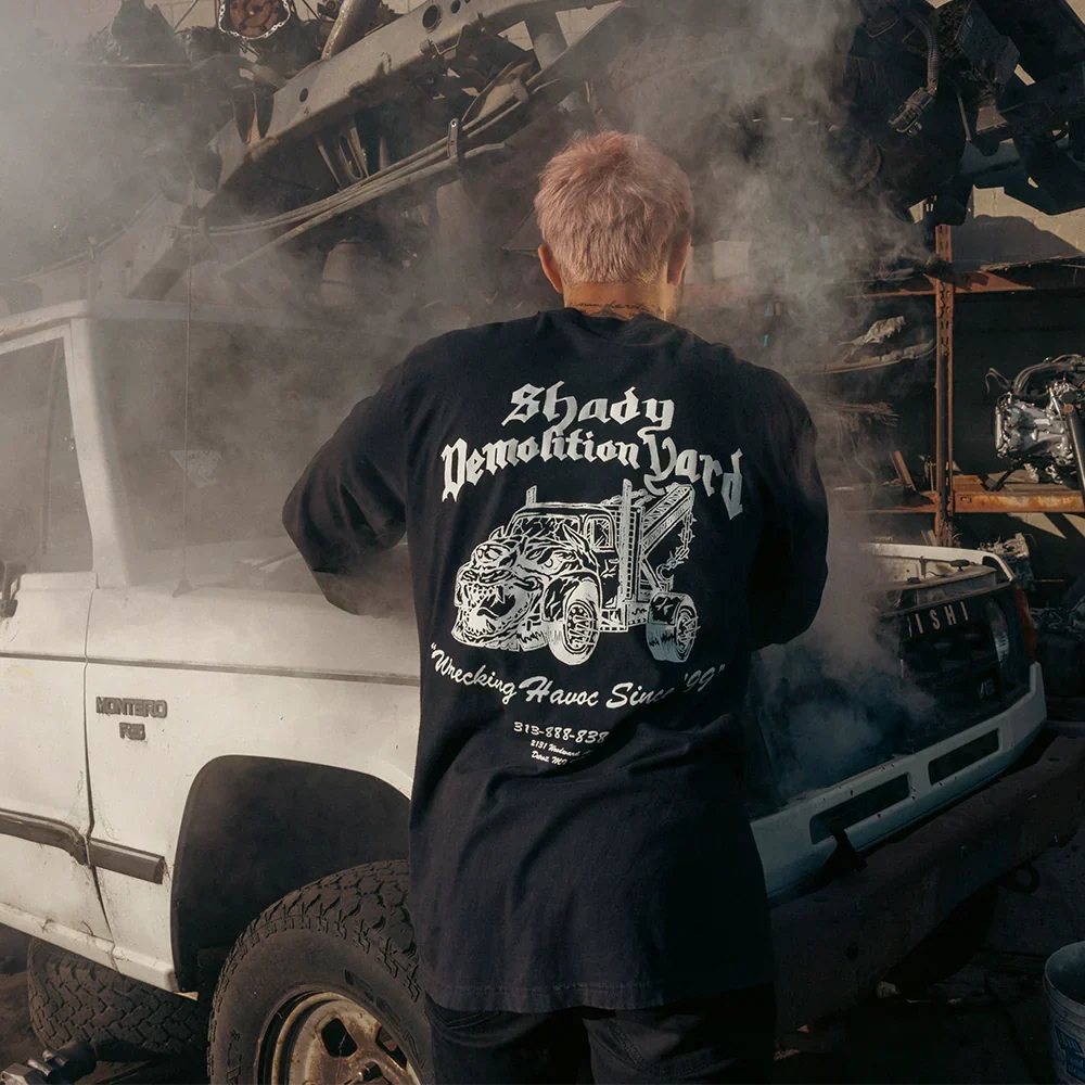 Back of the black Eminem Shady Demolition Barbed Wire long sleeve in a scrapyard