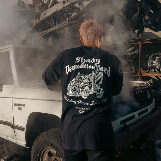 Back of the black Eminem Shady Demolition Barbed Wire long sleeve in a scrapyard