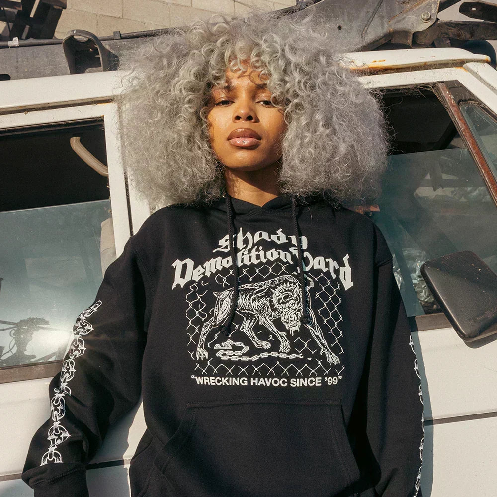 Woman wearing the black Eminem Shady Demolition Junkyard Dog hoodie with guard dog print