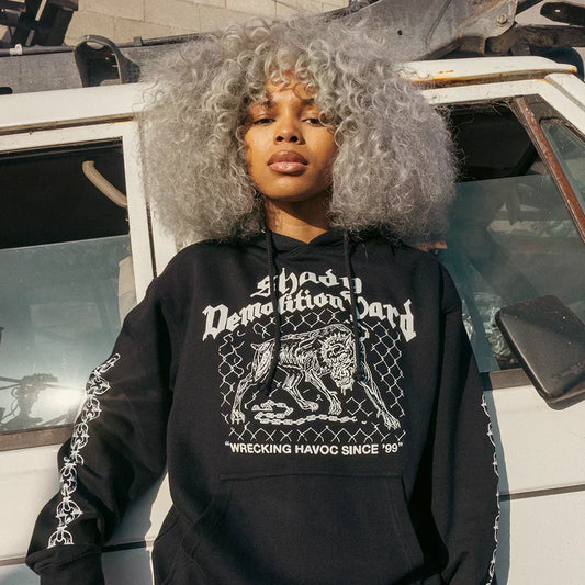 Woman wearing the black Eminem Shady Demolition Junkyard Dog hoodie with guard dog print