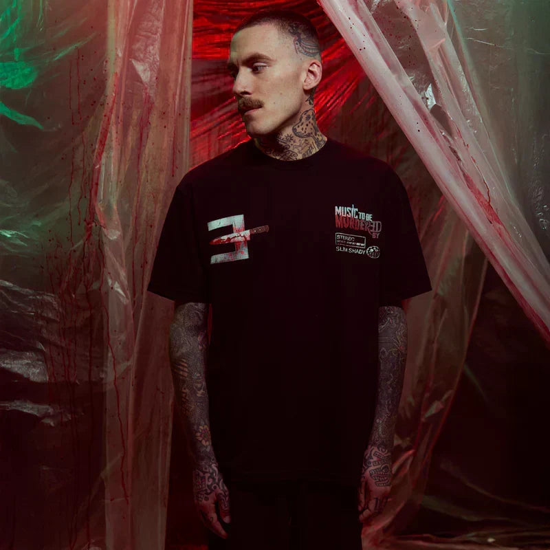 Man wearing the black Eminem Music To Be Murdered By anniversary T-shirt