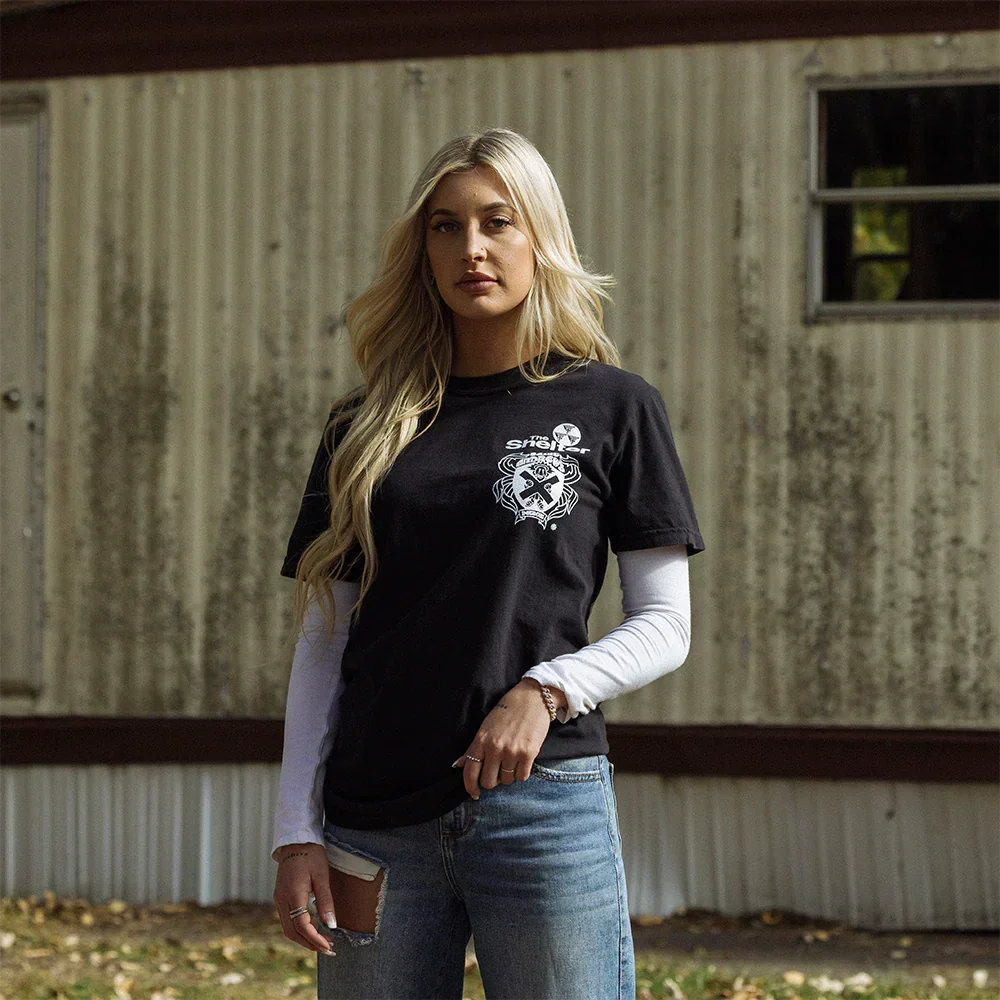 Woman wearing the black Eminem St. Andrews event T-shirt with small crest chest print