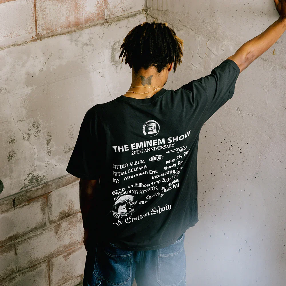 Man wearing the black Eminem Show 20th Anniversary T-shirt with tour date back print